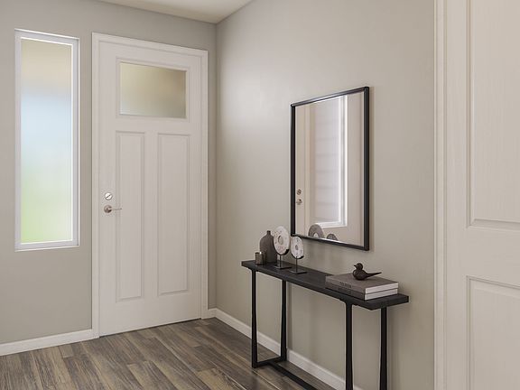 A modern and minimalist entryway with a wooden floor, a black console table, and a framed mirror on