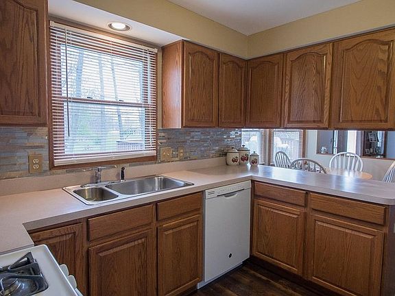Kitchen with new laminate floors, tile backsplash, and updated paint