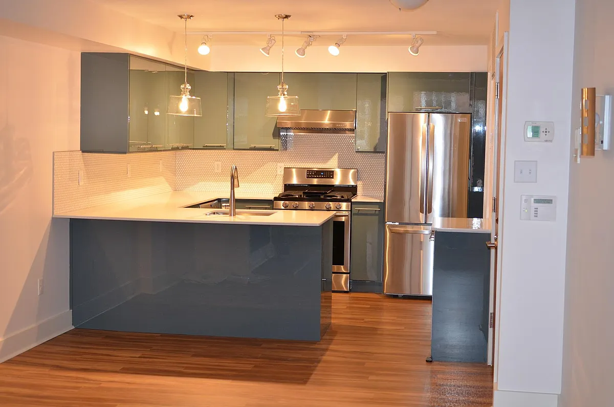 Kitchen with countertop dining - walk-in utility close with W/D in far right corner - 321 S Juniper St #A