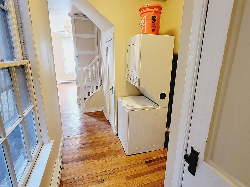 Entrance to #4. Right door is a large closet, great for coats. Stacked laundry straight ahead. Utility closet and stairs to the loft just past the laundry
