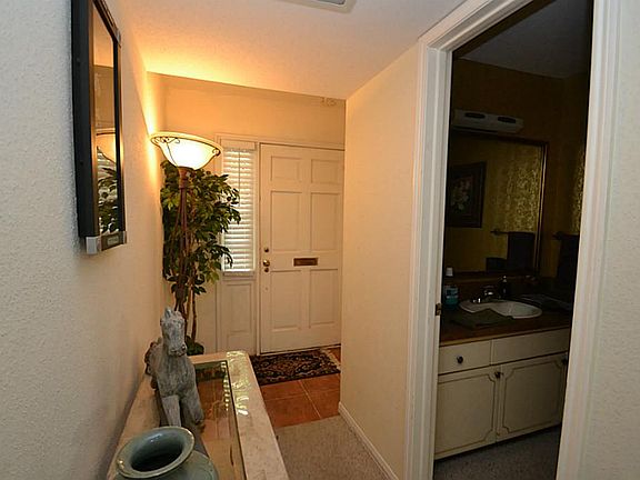 Entry with tile flooring and access to a half bath.