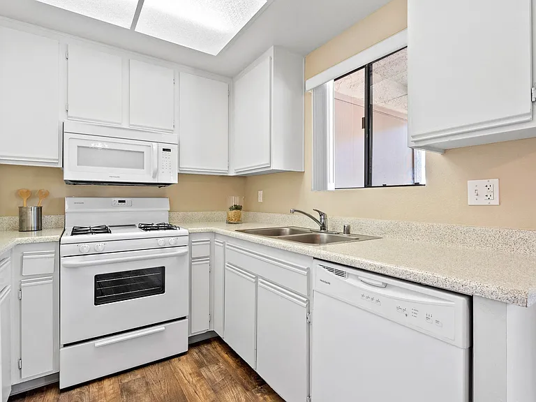 Kitchen with dishwasher at River Oaks in Oceanside, CA