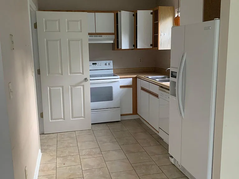 Kitchen is being remodeled with new cabinets, quartzite countertops, and stainless steel appliances.