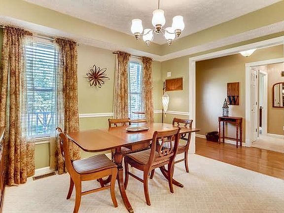 Dining area is off of entry foyer and kitchen.  Nice chandelier and spacious for china and butler cabinet.