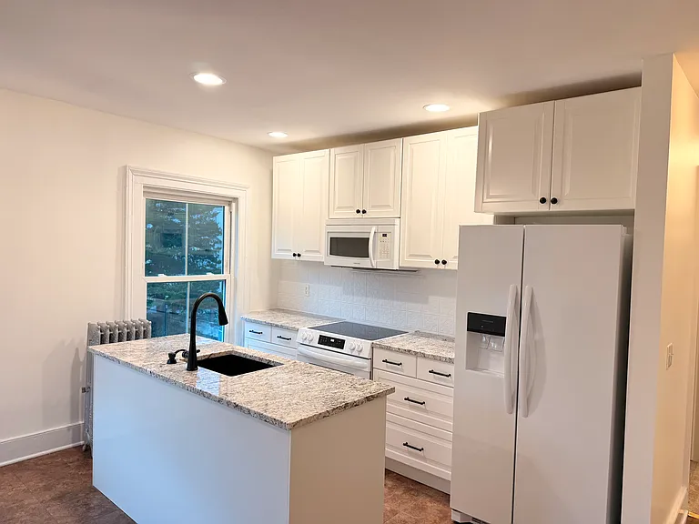 Refinished kitchen with granite, updated appliances, and fixtures.