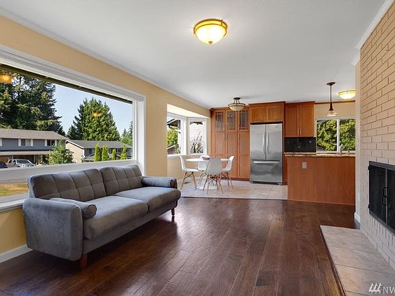 The family room features a huge picture window, wood burning fireplace, gleaming floors and open sight lines to the fabulous kitchen. You'll also find that all rooms upstairs feature updated lighting and crown molding.