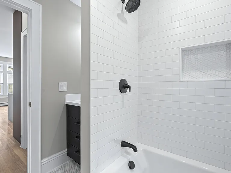 The bathroom sits between the two bedrooms and features natural light as well as beautiful lighting. The designer tiling in the brand new bathroom sparkles in your new oasis. It's all in the details!