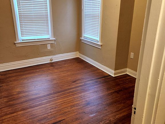 Clean bedroom with refinished pine hardwood flooring.