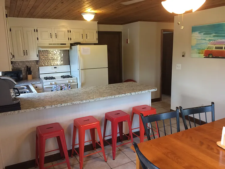 Kitchen, breakfast bar, dining table; door to utility closet and door to downstairs bathroom