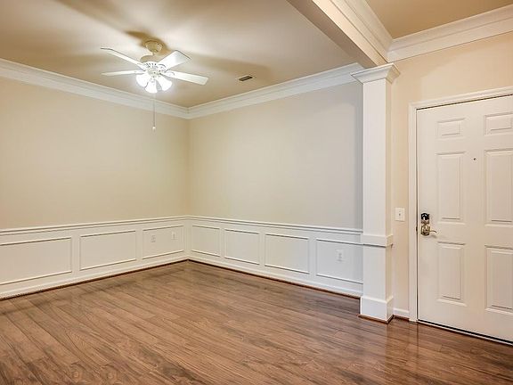 Dining room with crown molding and elegant chair rail. You will love to entertain here.