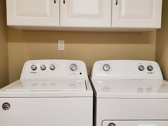 Full size washer and dryer in apartment.