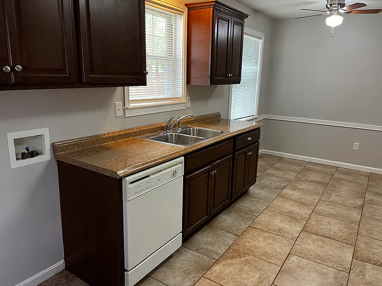 Bright kitchen overlooks backyard includes dining area, dishwasher, and washer/dryer hookups