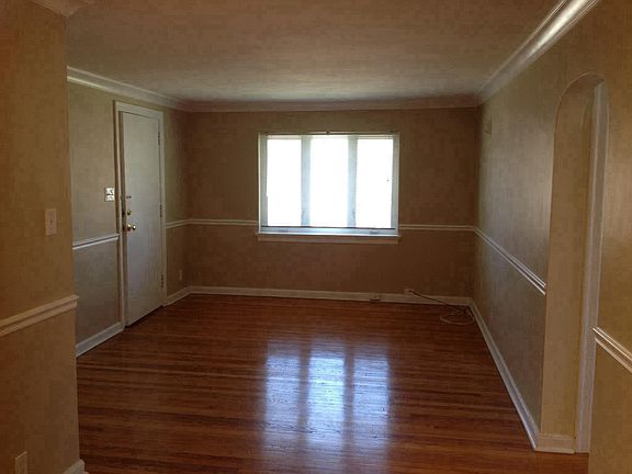 Front Door leading into Living Room. Newer Casement windows.