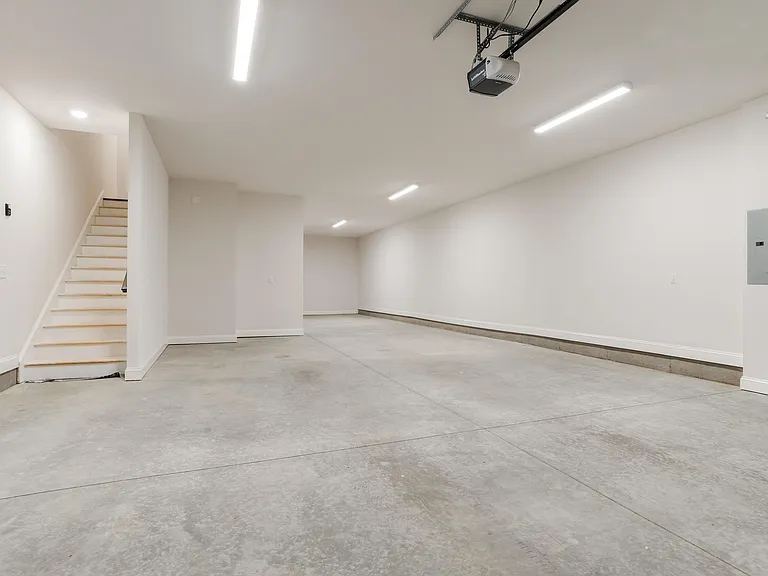 Basement/garage level offering over 1,300 sq ft with high ceilings, ideal for exceptional storage or flexible use. Features a rare 8' garage door, 3-car garage, a rare find for townhome living.