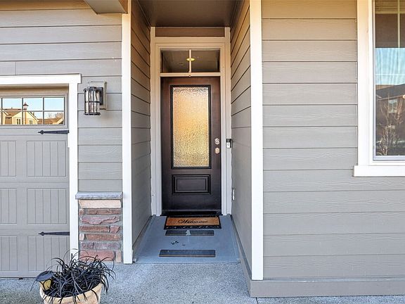 Charming covered front porch with removable wheelchair ramp at the front doorâ€”both practical and welcoming for everyday living and guests.>