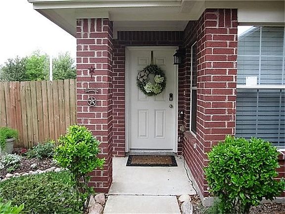 INVITING COVERED FRONT PORCH AREA WITH SOLID FRONT DOOR