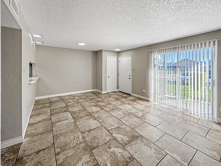 Large tile-floored dining space perfect for entertaining at Borders Apartments Brownsville TX.