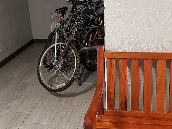 Indoor bike rack at entrance to laundry and storage room
