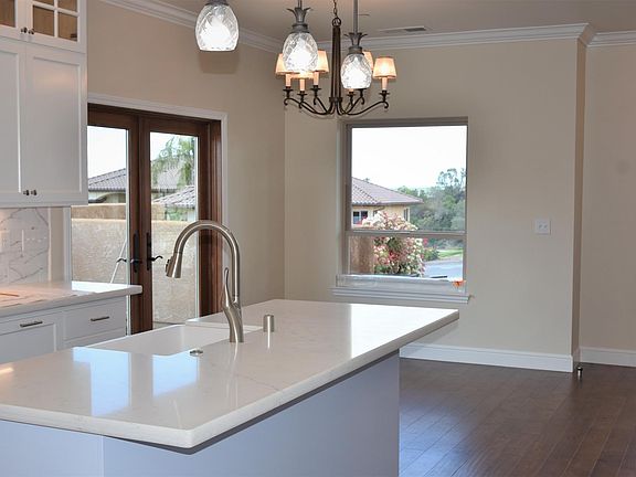Gourmet newly-built kitchen includes top-of-the-line appliances; range, microwave and large refrigerator with separate wine cooler bar area. The sunsets are amazing!