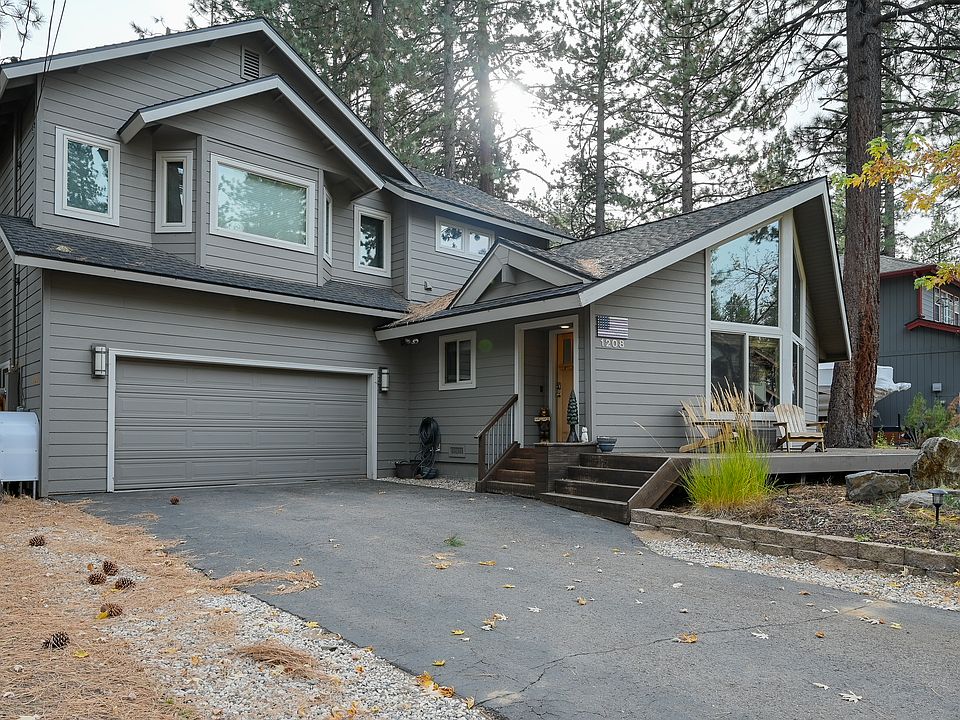 Large 2-story home with garage. Ample parking, with front porch, raised back deck and curated patio.