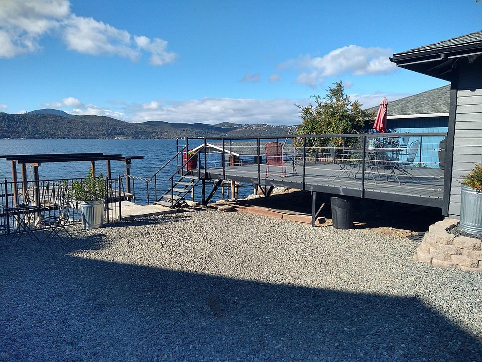 The deck overlooking the lake below and the stairs and ramp going to the sundeck over the water.