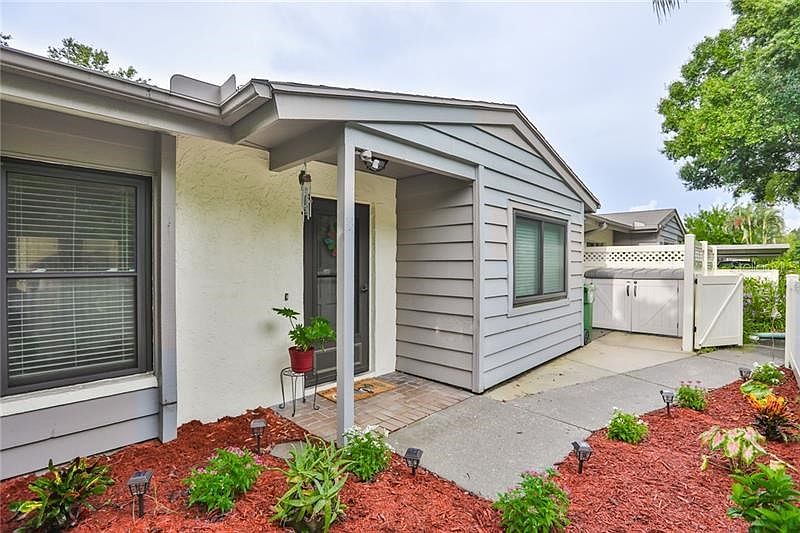 Picture of gated entry and front door. Home has Impact windows.