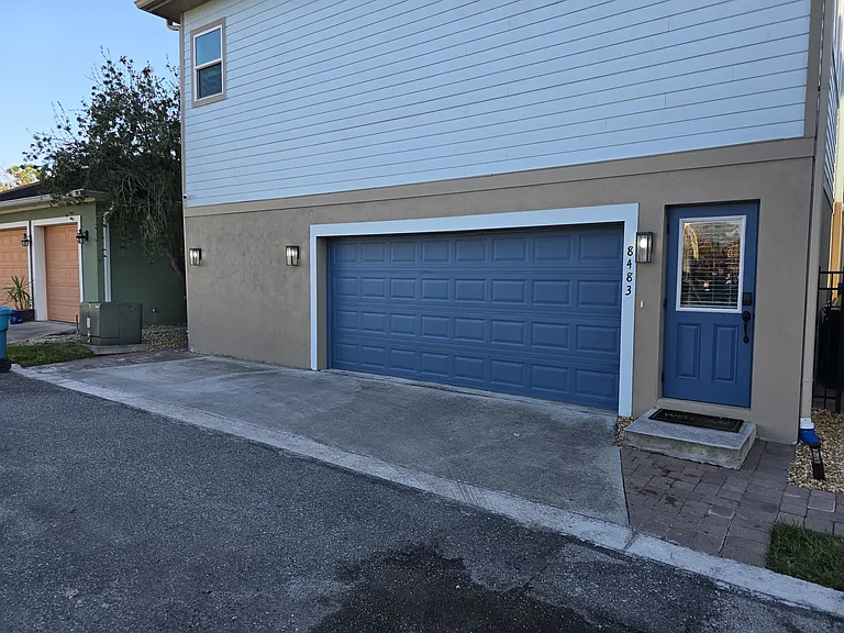 View of front door on the right and small landing spot on the left.