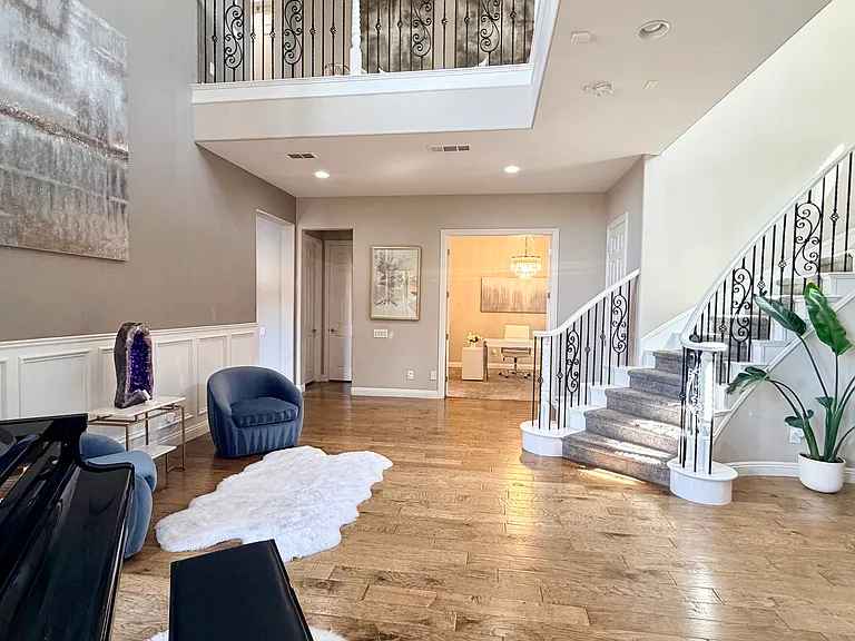 Foyer opens to bedroom with french doors and en suite full bath on main floor
