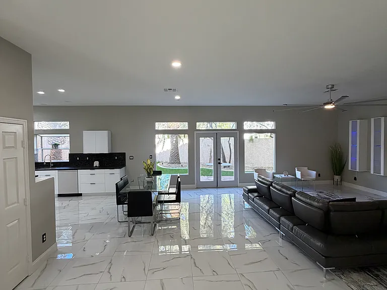 Open-concept main living and dining area with expansive windows and backyard access.