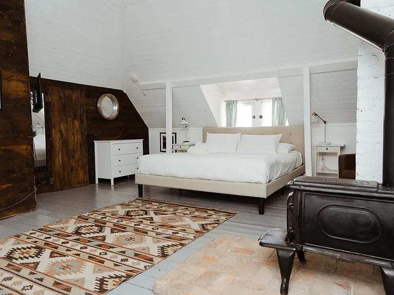 huge upstairs bedroom with soaring 26ft ceiling and wood burning fireplace