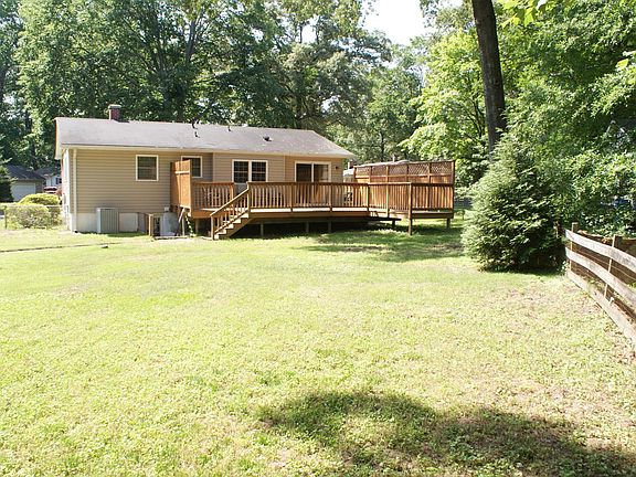 Fenced backyard with deck