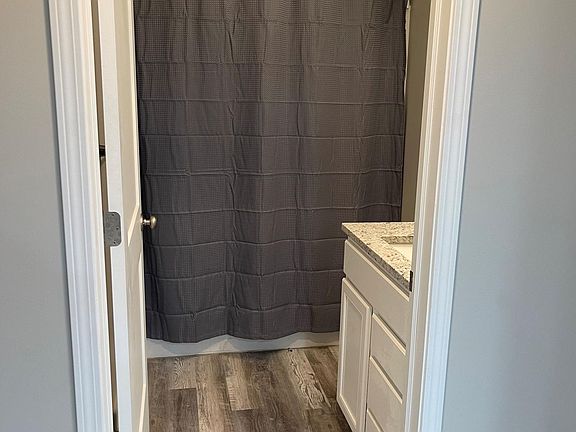 Granite countertops, custom light fixture, with wood-look luxury vinyl plank floors, white soft closet cabinet doors/drawers