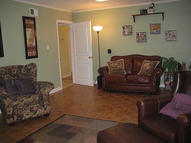Family room w. wood floors doubles as home theatre & opens to screened porch