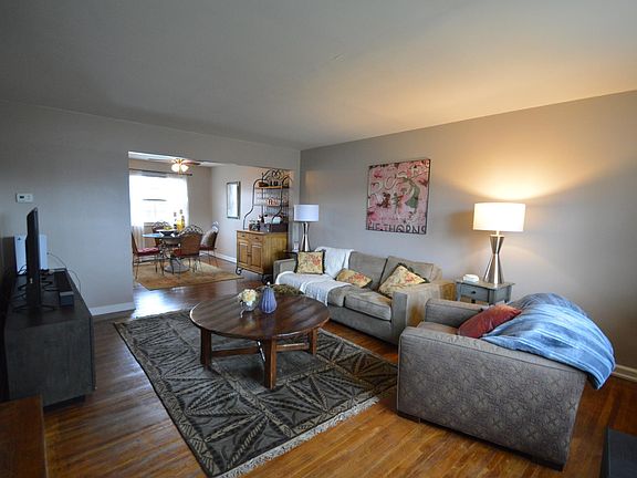 Living room with wood floors, coat closet at the entry