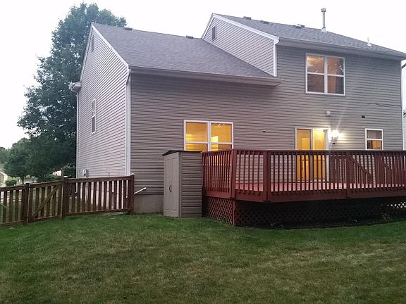 Side View of House with Storage Building and Deck