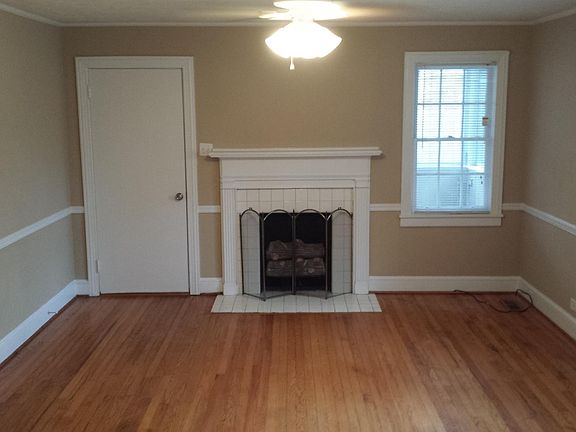 Large LR with gas logs and original hardwood flooring