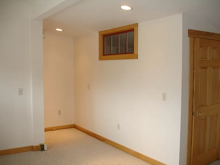 Entrance door not visible to left. Door to bedroom at right.
Window provides natural light to the bedroom
