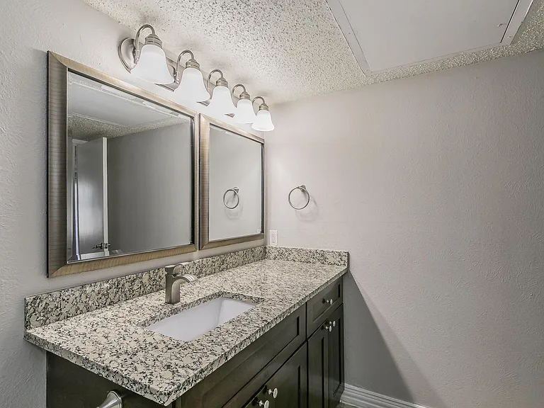Contemporary vanity design with bright lighting and storage.