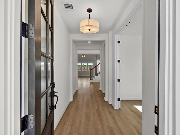 An inviting entry sets the tone, opening into a bright and spacious open-concept design