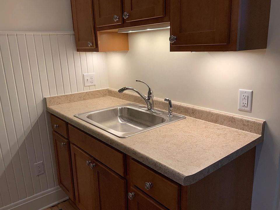 New kitchen cabinets showing under-cabinet lighting. Ample counter space for toaster and/or microwave oven.