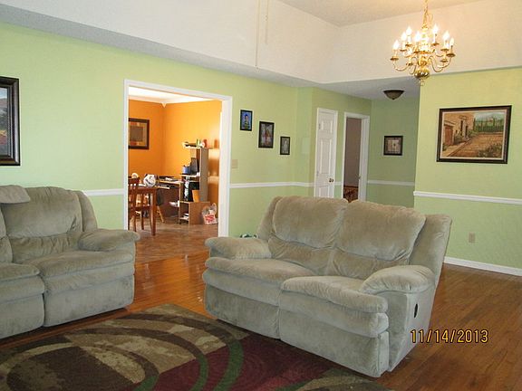 Living room with tray ceiling and hardwood floors