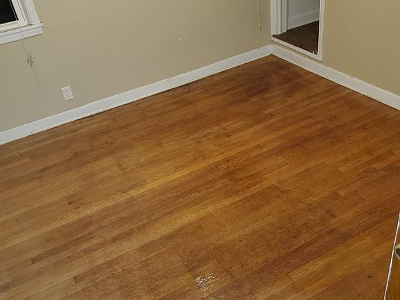1st bedroom newly finished original hardwood floors