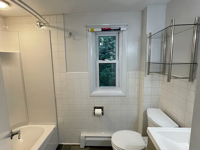 Full bathroom with tub and updated sink/toilet.