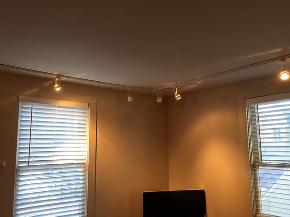 Living room features newly-installed track lighting. 