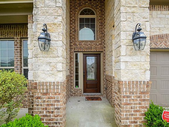 Close view of the entrance with an even better view of the brick and stone of this beautiful home!