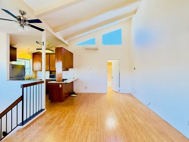 Living room looking towards master bed and bathroom. Kitchen is on the left. Vaulted ceilings