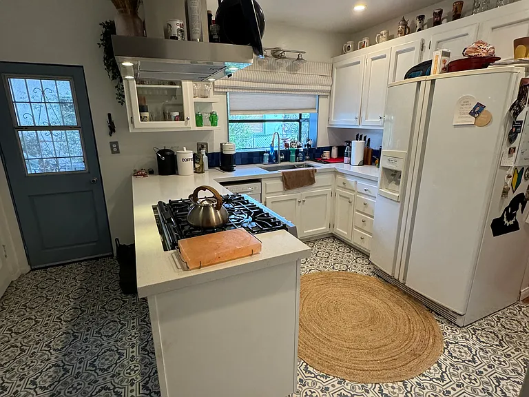 Kitchen includes dishwasher (to the left of the sink) and refrigerator