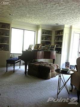 Double doors opening into a large formal living room, large enough to hold a Baby Grand!