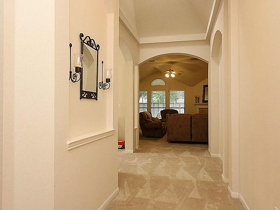 Spectacular entry features high ceilings with arched entryways that greet all who arrive with warmth