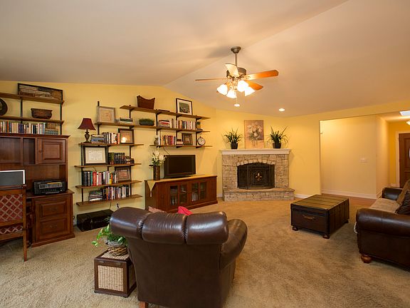 Spacious Family Room boasts new designer ceiling fan and plush carpet.
